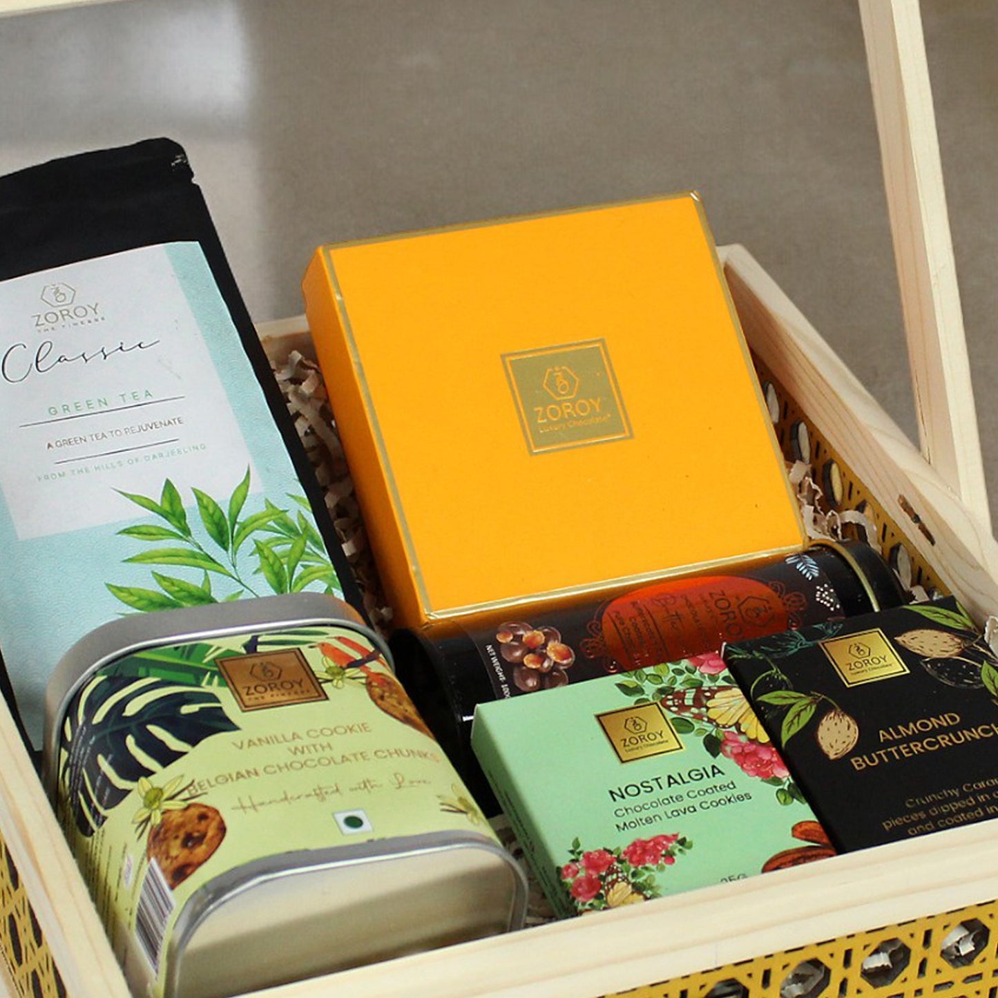 ZOROY Rakhi Special Wooden cane hamper with chocolates, green tea, cookies and coated nuts